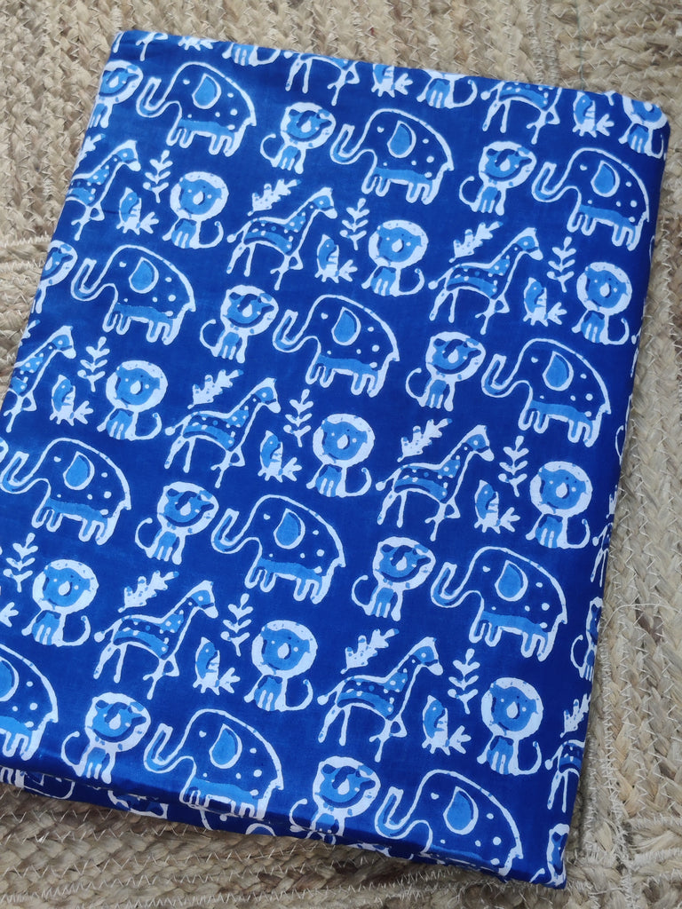 Blue fabric with white animal pattern on a beige carpet