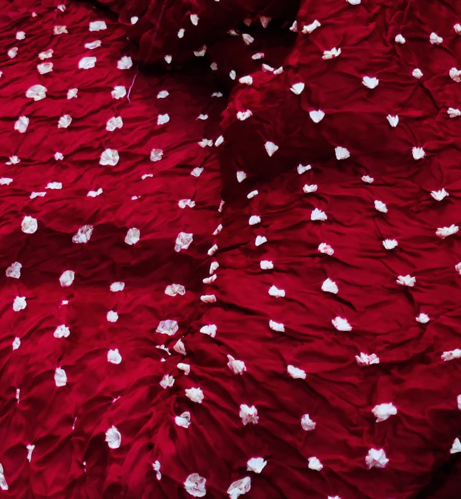 Close-up of red fabric with white floral patterns