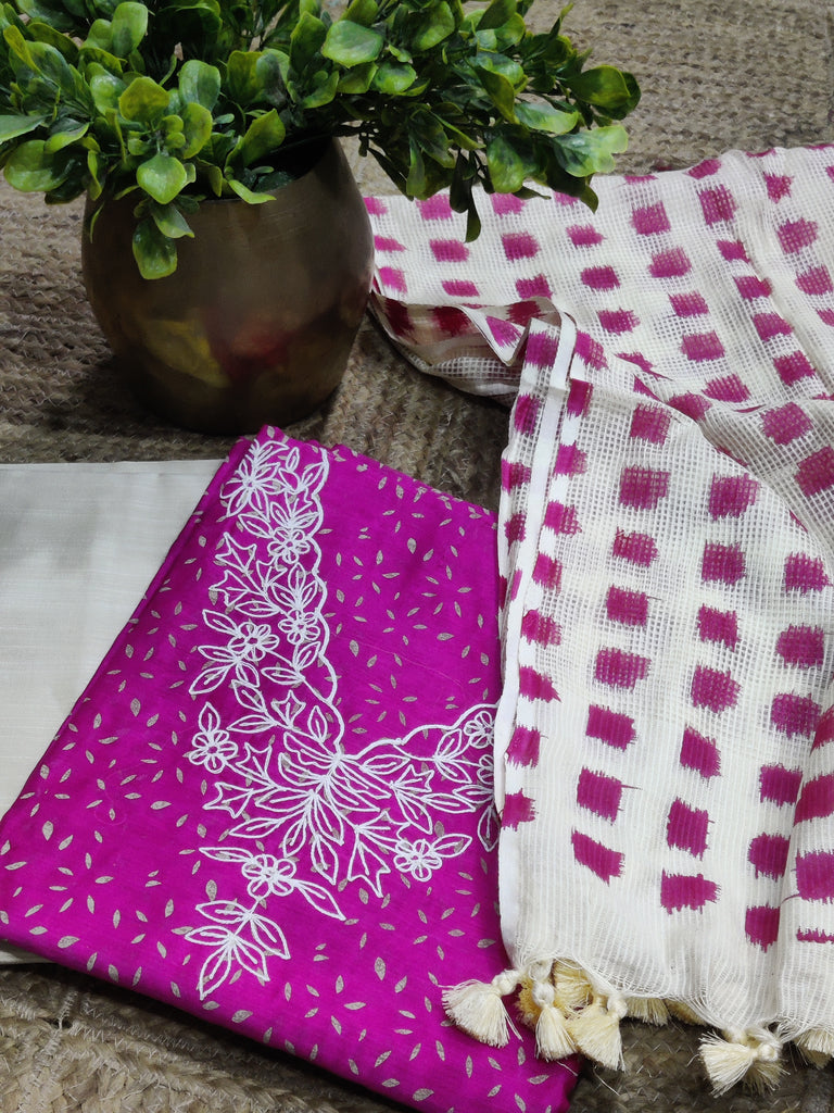 Purple fabric with white floral patterns and a checkered pattern on a textured surface.
