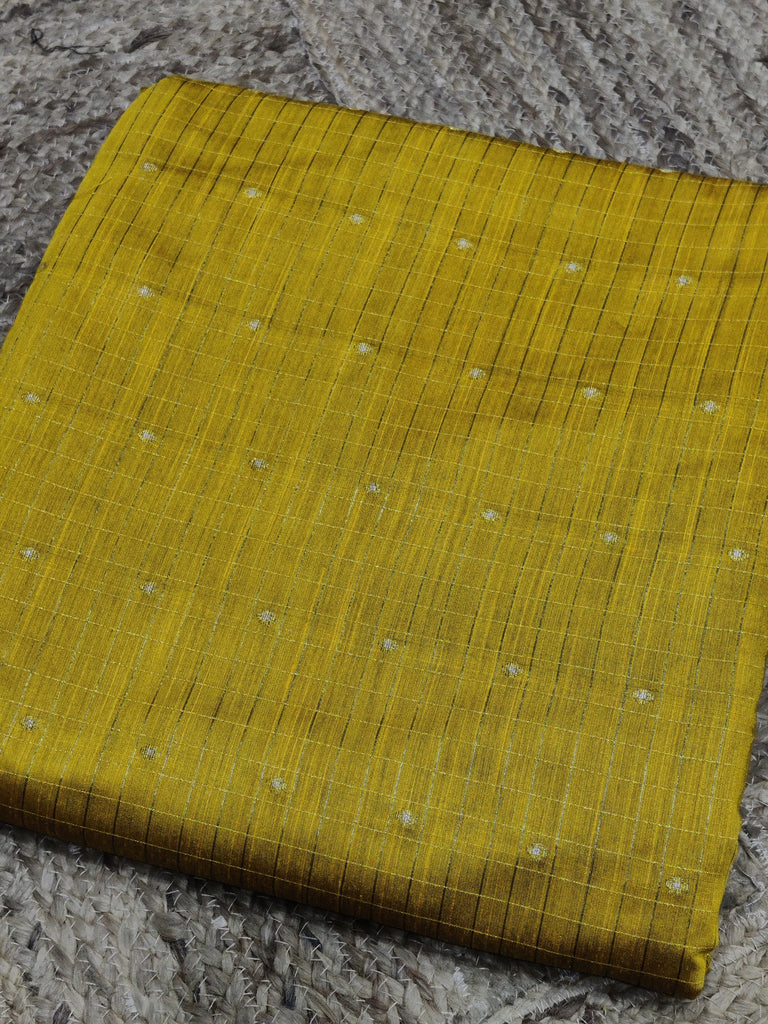 Yellow fabric with a subtle pattern on a textured surface
