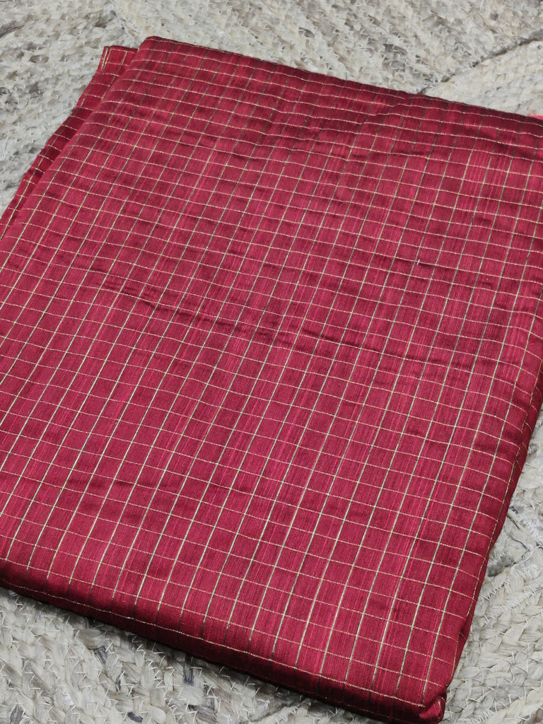 Red checkered fabric on a textured surface