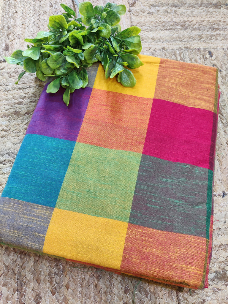 Colorful checkered tablecloth with a plant on a stone surface