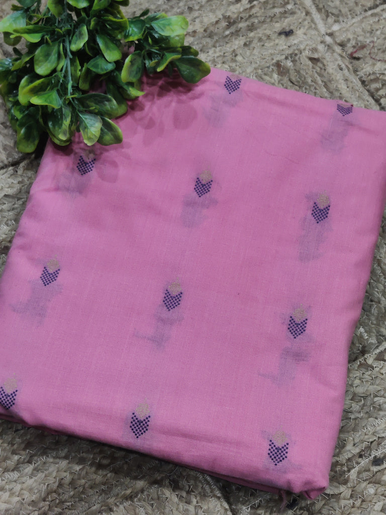 Pink fabric with embroidered patterns on a textured surface
