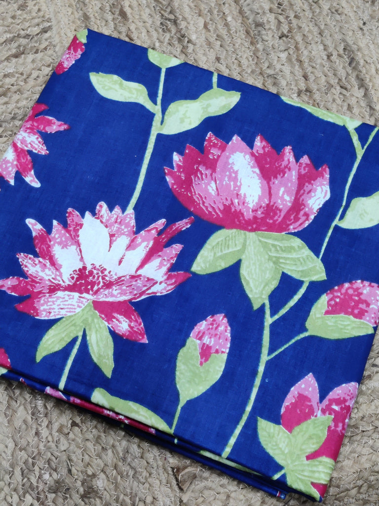 Floral fabric with pink and white flowers on a blue background