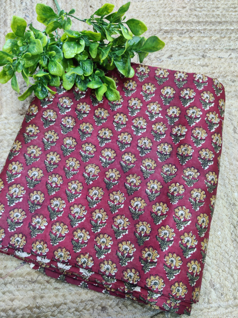 Floral-patterned fabric with a plant on a textured surface