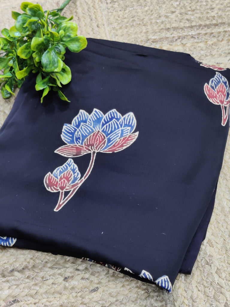 Navy blue fabric with red and white floral patterns on a textured surface.