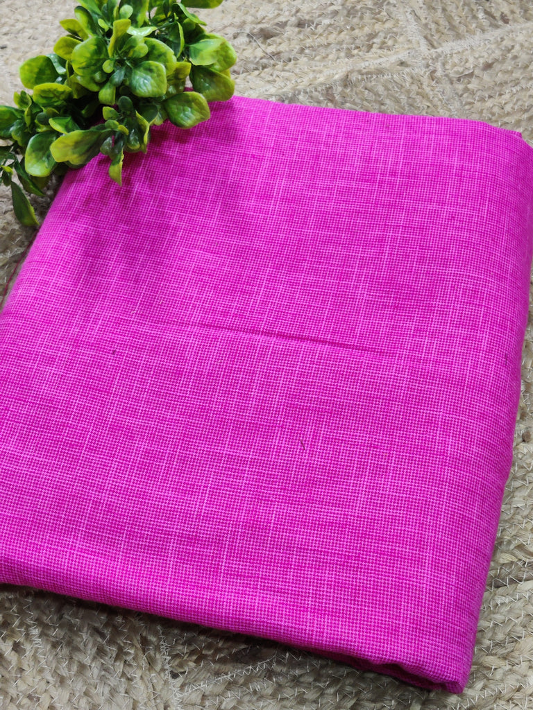 Purple fabric on a stone surface with green leaves.