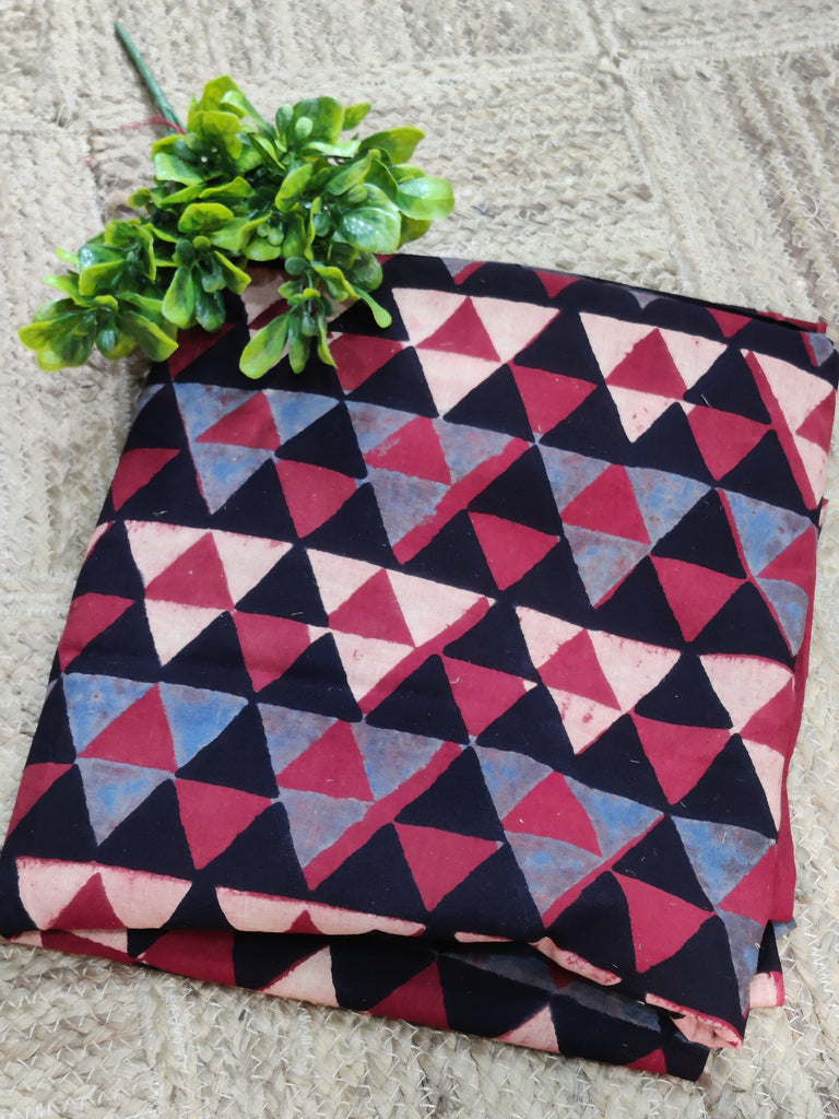 Folded fabric with a geometric triangle pattern on a textured surface