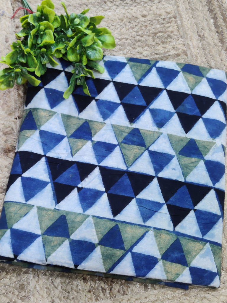 Fabric with blue and green triangle pattern on a textured surface