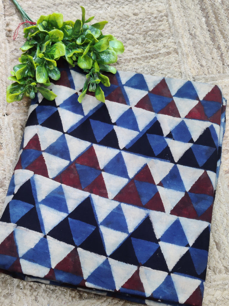 Geometric patterned blanket with triangles on a textured surface