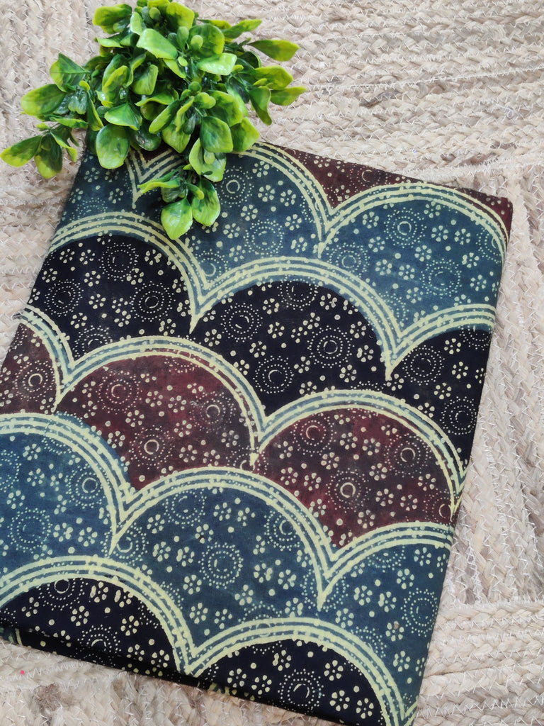 Decorative pillow with a pattern on a textured surface with a plant.