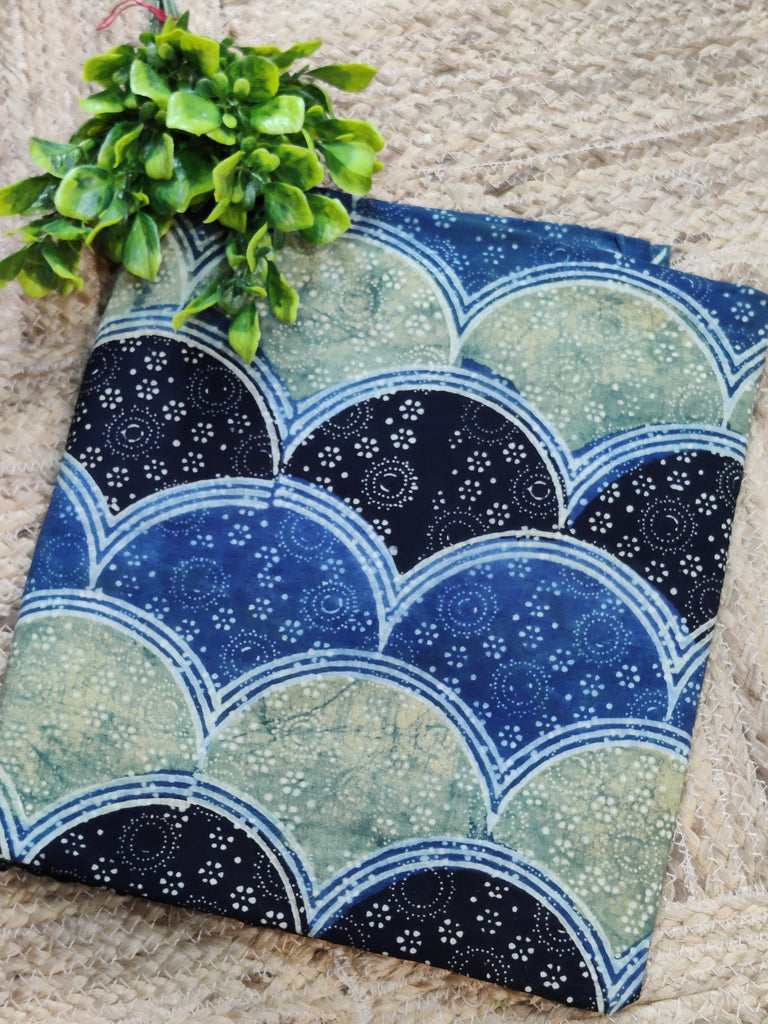 Decorative pillow with blue and black pattern on a textured surface