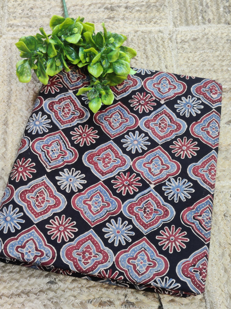 Decorative fabric with a geometric pattern on a stone surface