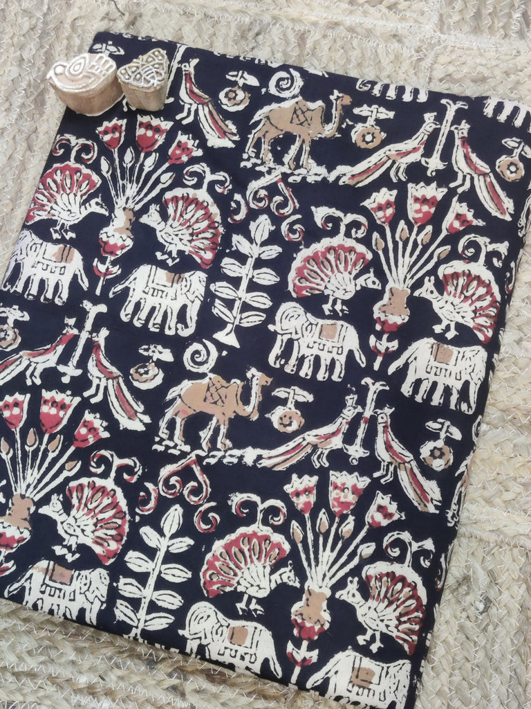 Black fabric with white and red animal patterns on a textured surface