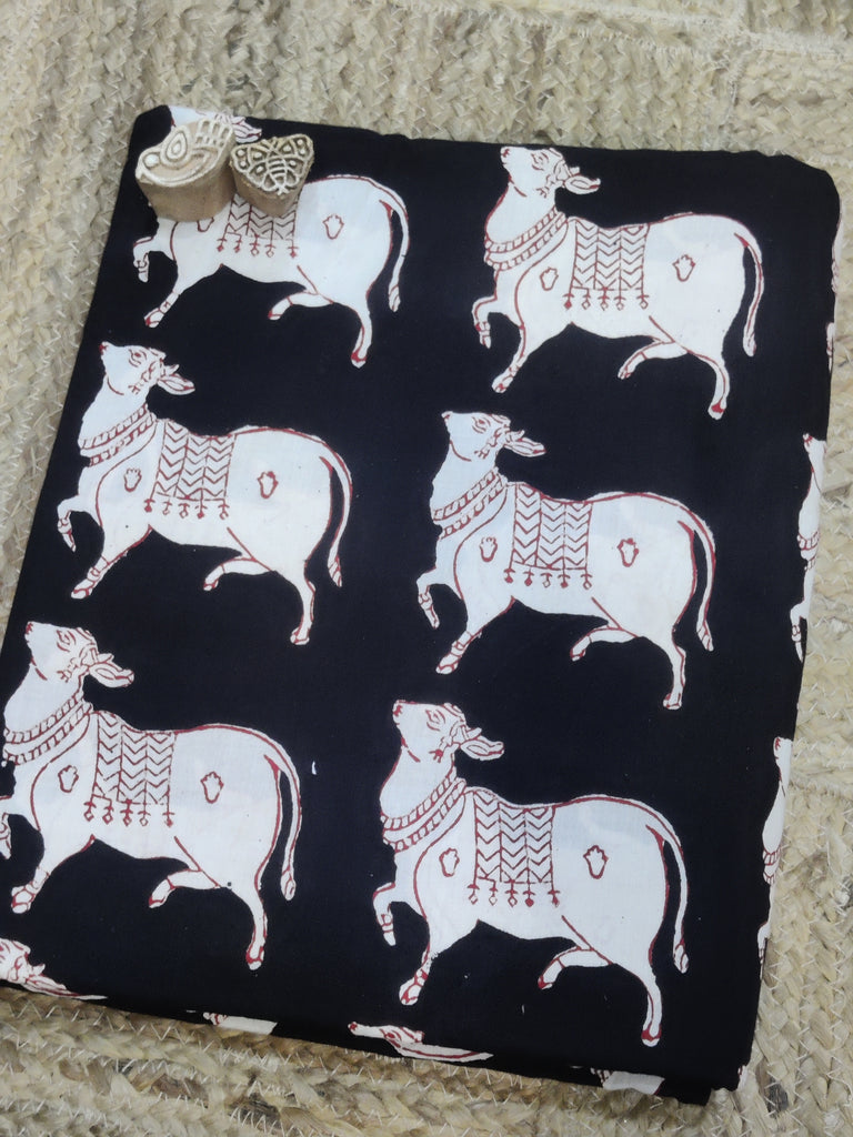Black fabric with white bull pattern on a textured surface