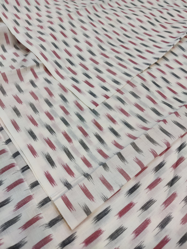 Ikkat Fabric with red and black abstract pattern on a white background